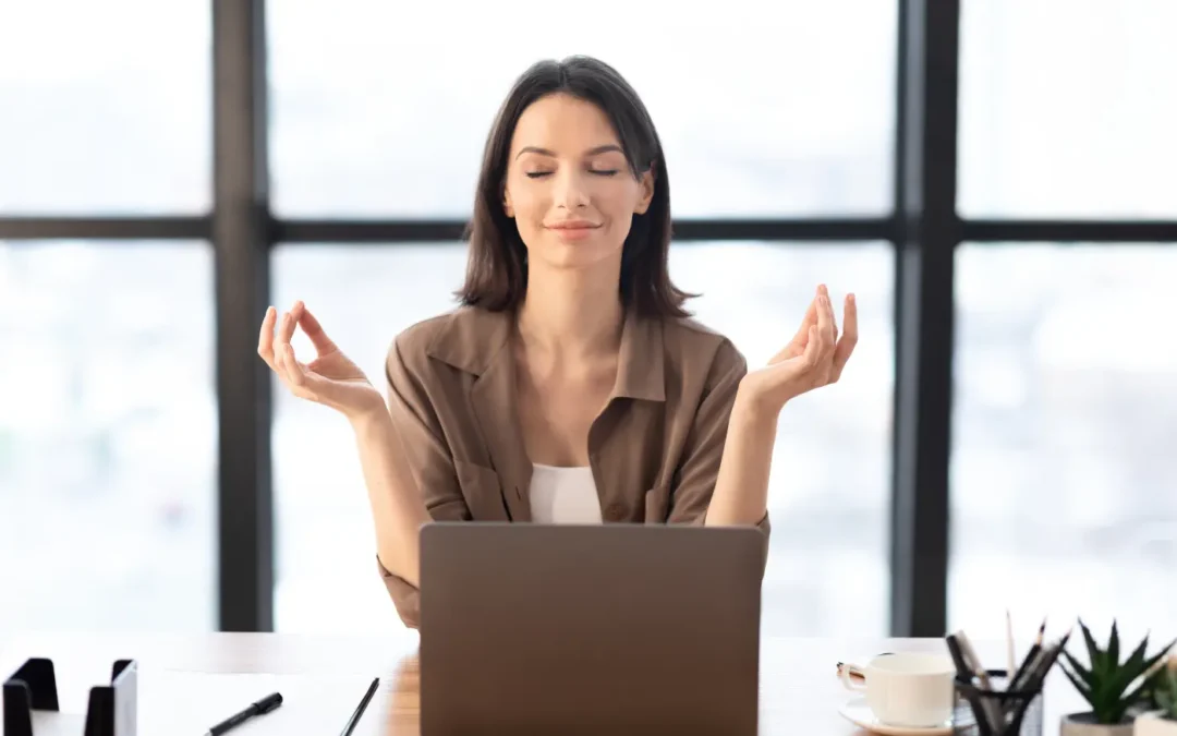 Person meditating at her computer